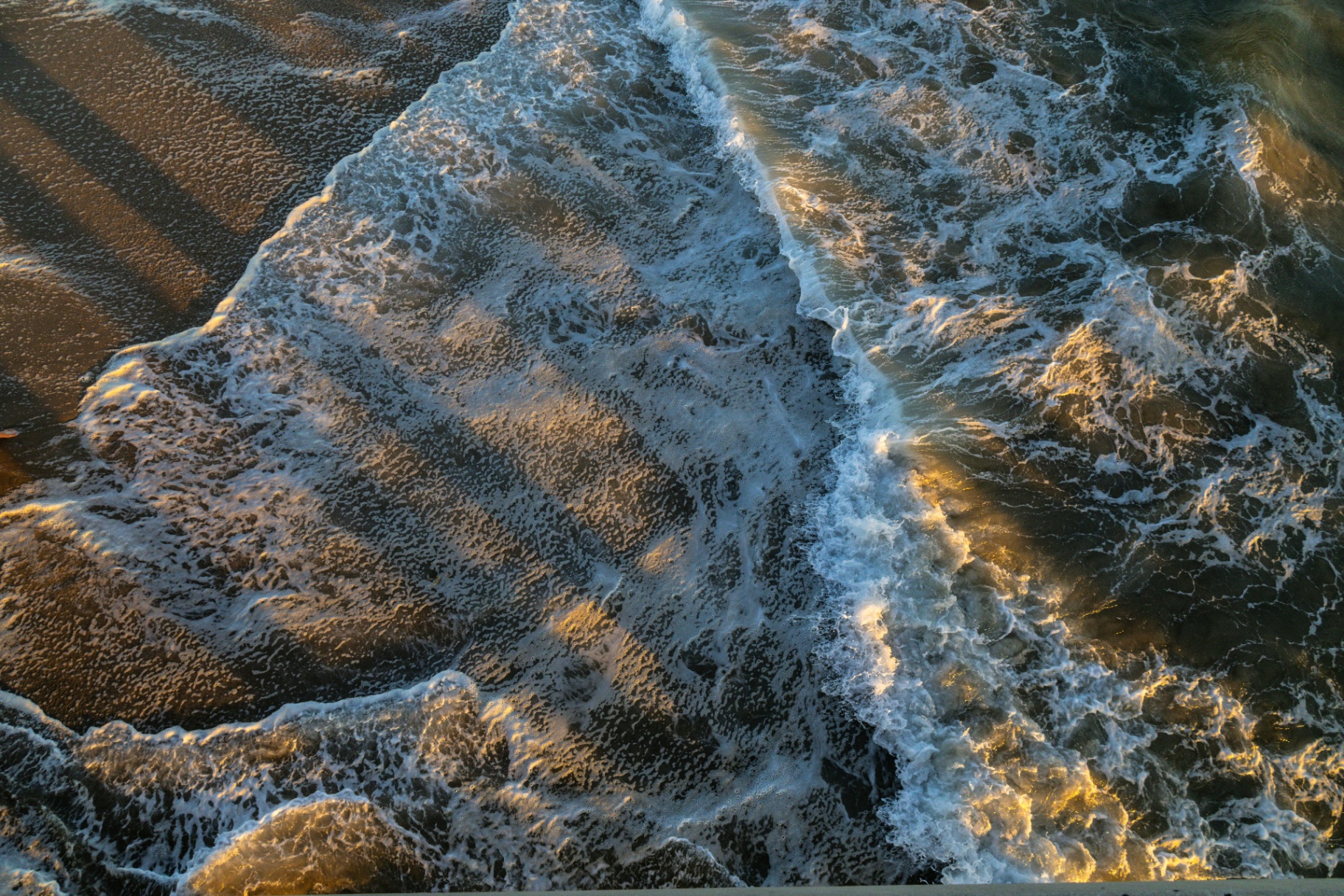 Waves rolling in at golden hour along the Huntington Beach shoreline